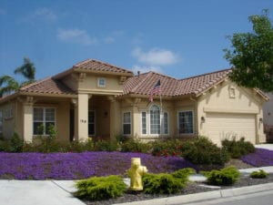 A picture of a beautiful house with purple flowers