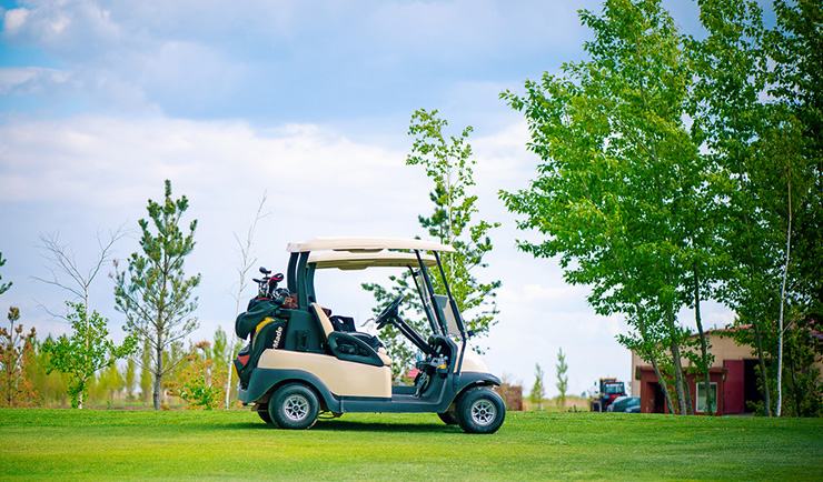 A club golf cart parked on a gold course