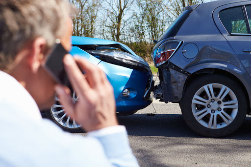 A person calling insurance for a car accident