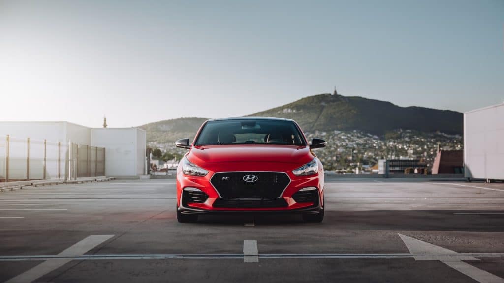 A picture of a sports car by Hyundai parked on a free way