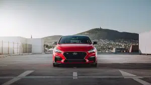 A picture of a sports car by Hyundai parked on a free way
